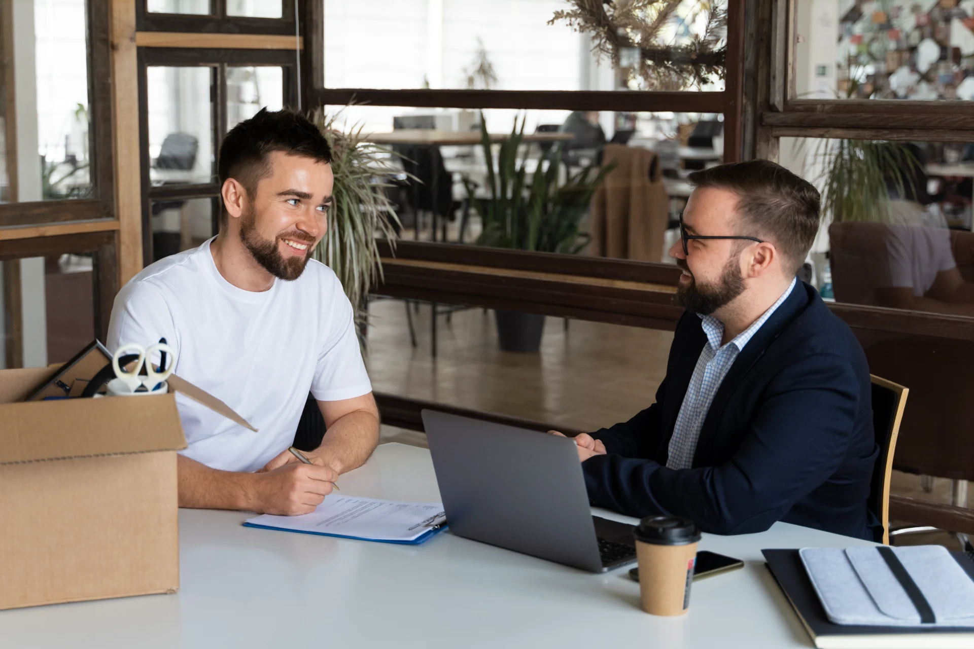 Employee handing over resignation letter during workplace consultation