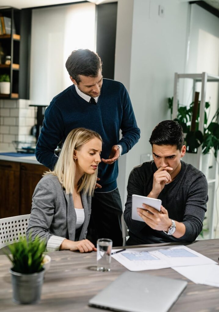 Couple discussing policy options with their insurance broker at home