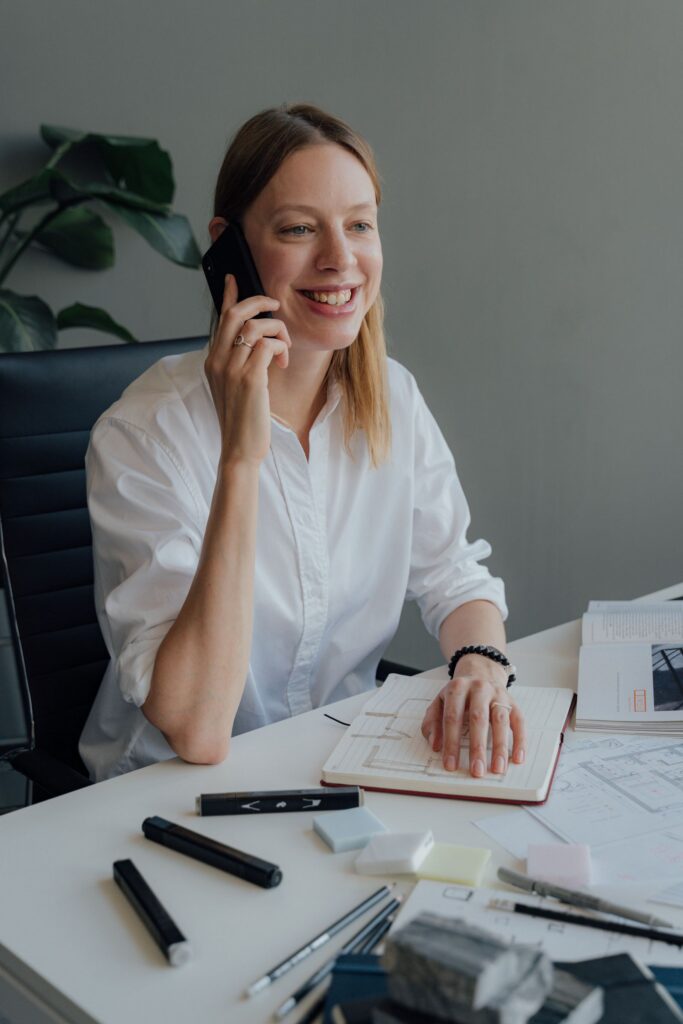 Professional services consultant on the phone at her desk