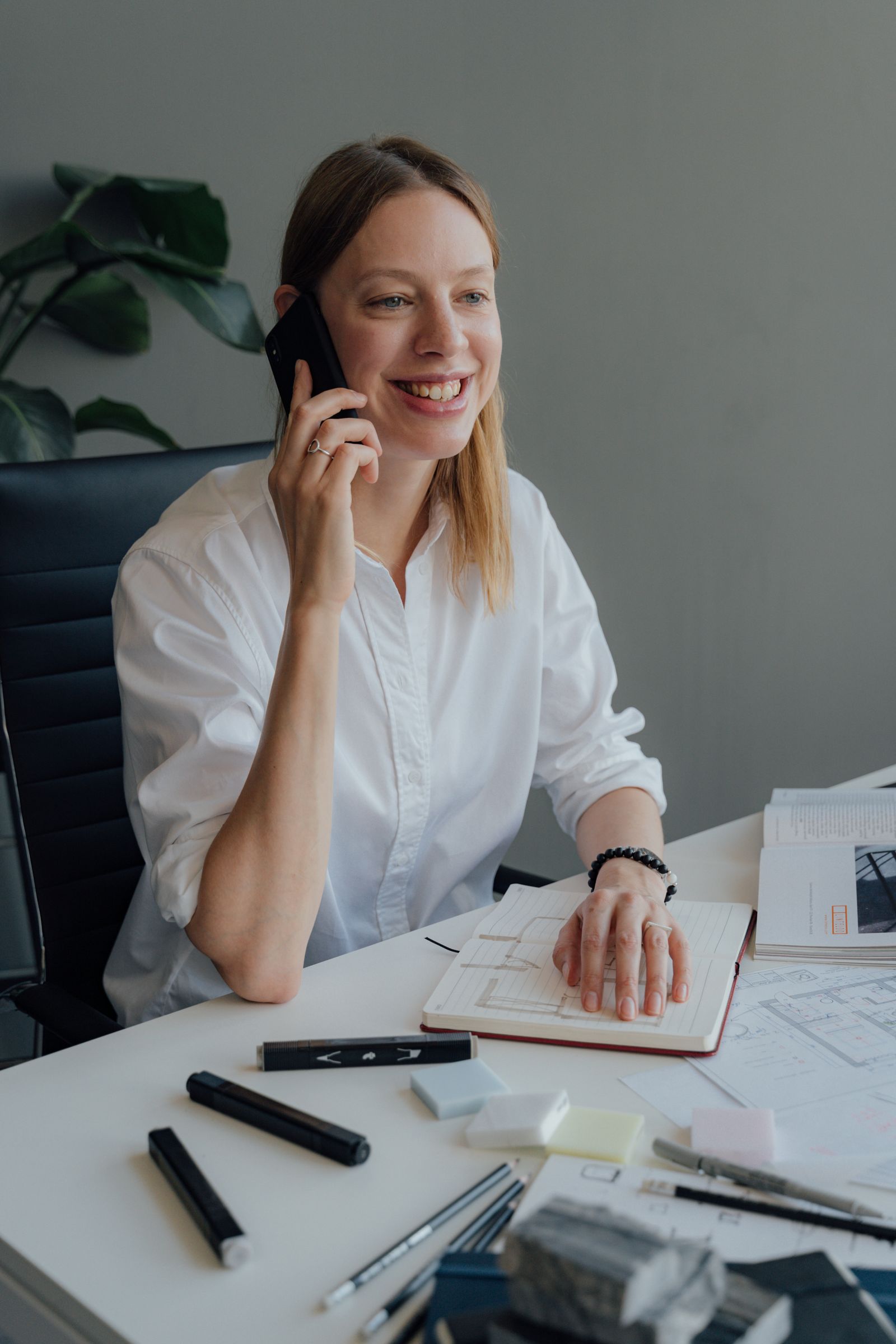 Professional services consultant on the phone at her desk