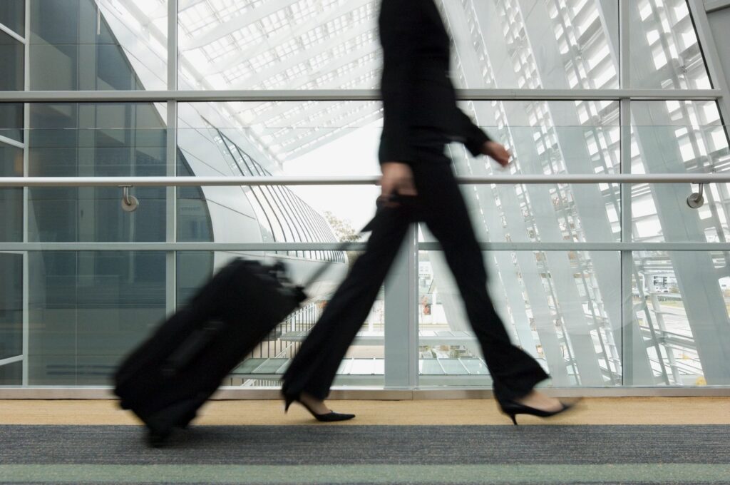 Traveller with luggage walking through an airport terminal