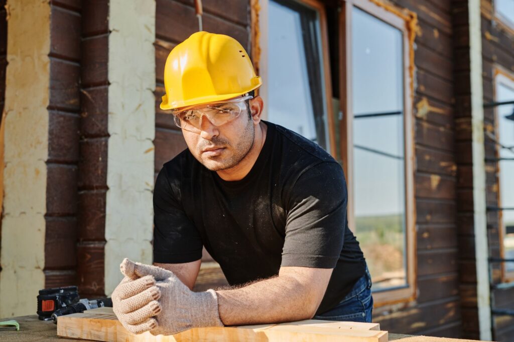 Builder in hard hat at a residential construction site