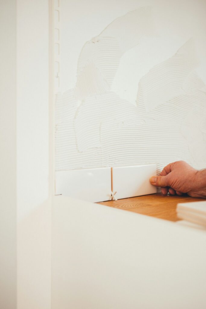 Tiler holding a tile, representing insurance for tilers
