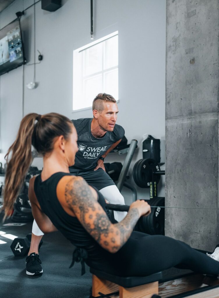 Personal trainer working out with a client