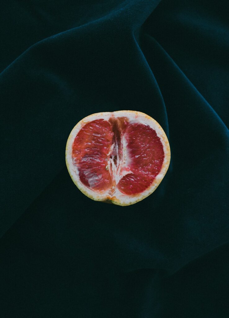 Grapefruit halves on a dark background